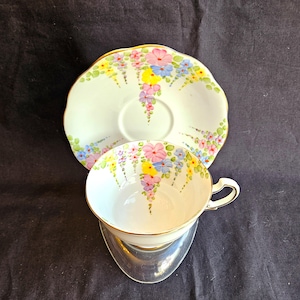Floral teacup & saucer, hand painted pink, purple, yellow, blue, pattern #533, gold trim, marked Made in England Bone China Exc vintage cond