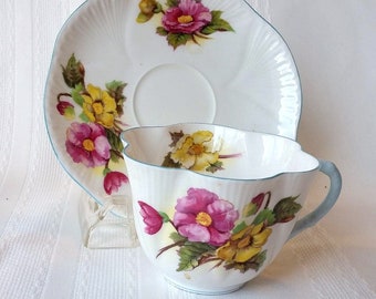 Shelley Bone China Begonia teacup & saucer, Dainty shape, pink and yellow with blue trim, pattern #13427 Excellent vintage condition