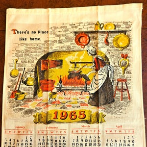 May include: Vintage kitchen towel with a calendar for 1965. The illustration depicts a woman cooking in a fireplace, surrounded by kitchen tools. Text reads "There's no Place like home."