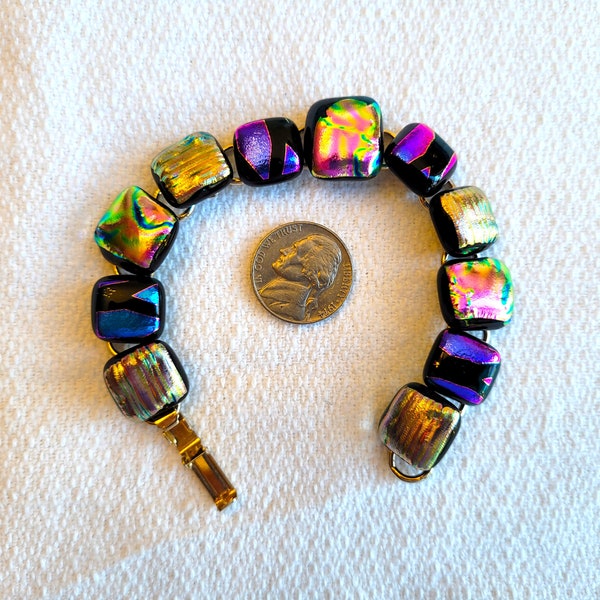 Dichroic glass link bracelet, predominently purple & gold glass cabochons on goldtone metal, signed 7" long, Excellent vintage condition