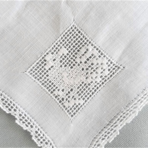 May include: White linen handkerchief featuring a diamond-shaped, openwork lace centre and a delicate lace border. The fabric has a subtle texture, and the lace detailing adds elegance. A classic accessory, perfect for special occasions.