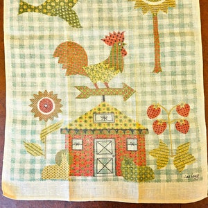 May include: A vintage farmhouse-themed kitchen towel with a green and white checkered background. The towel features a rooster weather vane, a red barn, sunflowers, strawberries, and a bird. The design is in shades of red, yellow, green, and brown.