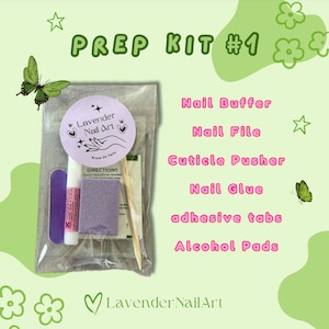 May include: A clear plastic bag filled with a nail prep kit. The kit includes a nail buffer, nail file, cuticle pusher, nail glue, adhesive tabs, and alcohol pads. The bag also includes a small purple sticker with the text "Lavender Nail Art" and a small white card with the text "DIRECTIONS Apply sparingly as needed".