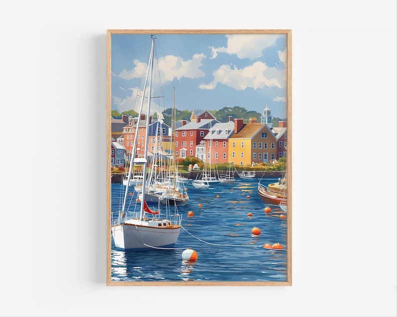 May include: A framed print of a harbor scene with sailboats and colorful buildings. The artwork depicts a sunny day with a blue sky and fluffy white clouds. Orange buoys float in the water, adding a pop of color to the scene.