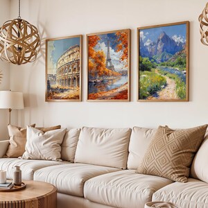 May include: Three framed art prints depicting famous landmarks. The first print shows the Colosseum in Rome, the second print shows the Eiffel Tower in Paris, and the third print shows a mountain range with a river flowing through it.