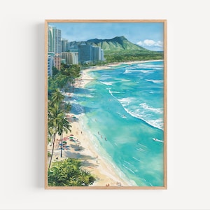 May include: A framed watercolor print of a tropical beach scene. The artwork depicts a turquoise ocean, sandy beach, palm trees, and buildings. A mountain is visible in the background under a blue sky. The artwork is framed in a light brown wooden frame.