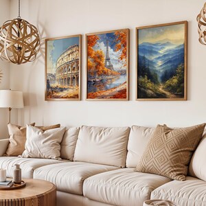 May include: Three framed art prints hanging on a white wall. The prints feature a scenic view of the Eiffel Tower in Paris, a view of the Colosseum in Rome, and a mountain landscape.
