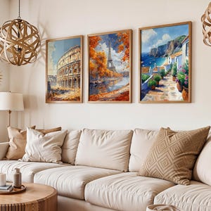 May include: Three framed art prints depicting scenes from different cities. The first print shows the Colosseum in Rome, the second print shows the Eiffel Tower in Paris, and the third print shows a coastal village with white buildings.
