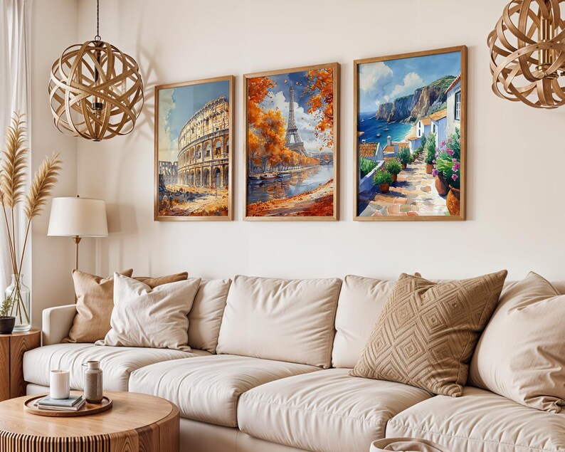 May include: Three framed art prints depicting scenes from different cities. The first print shows the Colosseum in Rome, the second print shows the Eiffel Tower in Paris, and the third print shows a coastal village with white buildings.