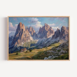 Könnte beinhalten: Gerahmtes Landschaftsgemälde eines Gebirges mit zerklüfteten Gipfeln unter blauem Himmel mit Wolken. Am Fuße der Berge befindet sich ein kleines Gebäude, umgeben von grünem Gras und Bäumen. Das Gemälde ist in einem Holzrahmen.