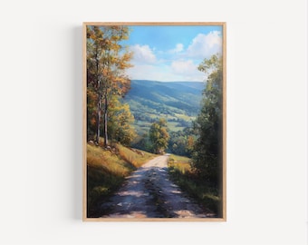 Könnte beinhalten: Gerahmtes Landschaftsgemälde, das eine unbefestigte Straße durch ein Tal zeigt. Das Kunstwerk zeigt einen blauen Himmel mit Wolken, sanften grünen Hügeln und Bäumen mit gelben und orangefarbenen Blättern. Der Rahmen ist aus hellem Holz.