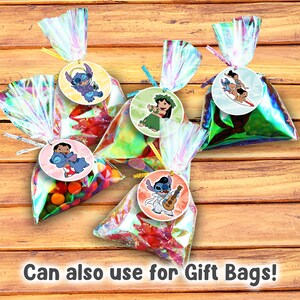May include: Several cellophane gift bags filled with colorful candies, each tied with a ribbon and a circular tag featuring a cartoon character. The bags are on a wooden surface. Text at the bottom reads: "Can also use for Gift Bags!"
