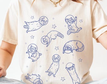 宇宙アライグマシャツ - かわいい宇宙飛行士アライグマTシャツ、宇宙動物シャツ、面白いアライグマギフト、おかしなスペースコアシャツ、星空のゴミパンダ