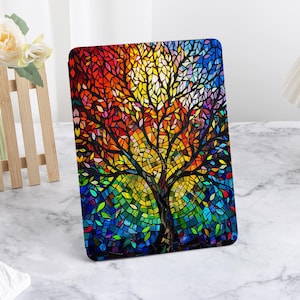 May include: A colorful tablet case featuring a mosaic-style tree design. The artwork showcases a vibrant spectrum of colors, including red, orange, yellow, green, blue, and purple, creating a stained-glass effect. The tree's branches and leaves are intricately detailed.