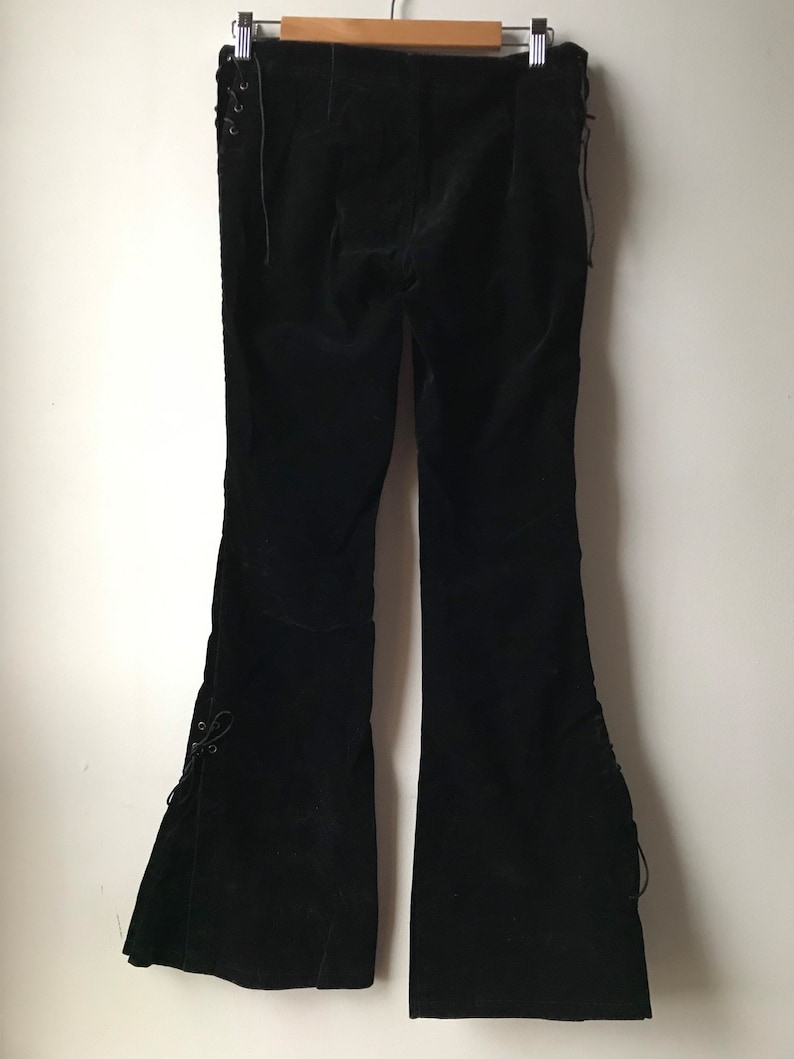 K&ouml;nnte beinhalten: Schwarze Samt-Hose mit Schn&uuml;rdetails an den Seiten und am Beinabschluss.