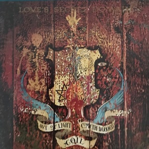 May include: A vintage album cover with a dark, textured background. The cover features a stylised image of a heart, a star, and a hand reaching up. The text "Love's Secret Domain" and "Coil" are visible on the cover.