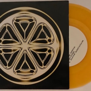 May include: A vinyl record and its sleeve. The sleeve is black with a circular, geometric design in cream and tan. The record is a translucent orange colour. Text on the label reads "Summer Solstice: Side Stings, Summer Substructures."