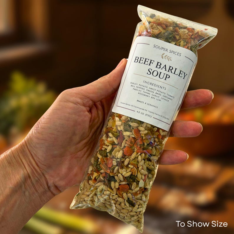 May include: A clear plastic pouch of dry soup mix labeled Souper Spices Beef Barley Soup. The label lists ingredients including barley, potato, sweet potato, tomato, onion, basil, oregano, bell peppers, garlic, lovage, parsley, thyme, and bay leaf.