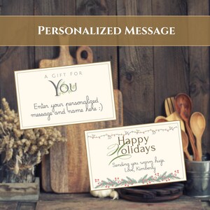 May include: Two rectangular gift cards with cream backgrounds and thin borders. One card reads A GIFT FOR YOU and Enter your personalized message and name here. The other card reads Happy Holidays, Sending you warm hugs. Love, Kimberly with festive lights.