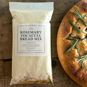 May include: A set of three ceramic nesting bowls in shades of blue, green, and white. The bowls feature a speckled glaze and a simple, modern design. The largest bowl measures approximately 6 inches in diameter.