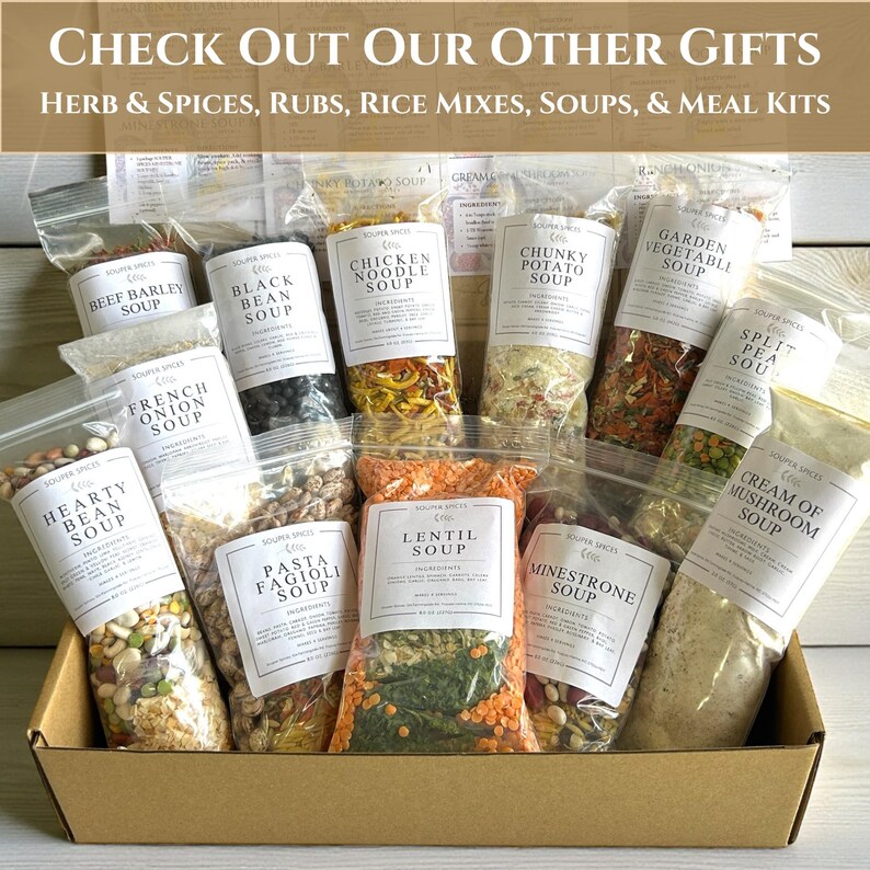 May include: A cardboard box filled with various clear plastic pouches containing dry soup mixes. Labels include Beef Barley, Black Bean, Chicken Noodle, Chunky Potato, Garden Vegetable, Split Pea, French Onion, Hearty Bean, Pasta Fagioli, Lentil, Minestrone, and Cream of Mushroom.