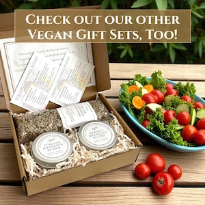 May include: A cardboard box filled with vegan gift set items, including dressing blends, salad toppings, and small metal tins. The box also contains recipe cards. The text on the image reads: "CHECK OUT OUR OTHER VEGAN GIFT SETS, TOO!"