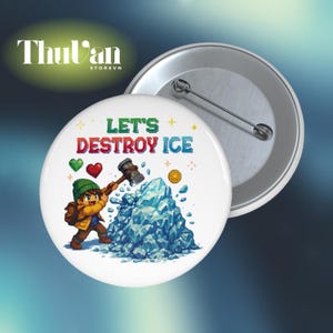May include: White badge with the text "LET'S DESTROY ICE" in colourful letters. An illustration shows a cartoon character with a hammer breaking a blue ice formation. A second badge is visible.