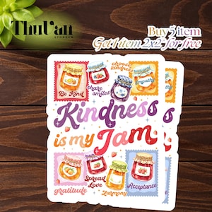 May include: A stack of stickers with a wooden background. The stickers feature colorful illustrations of jam jars with various fruits and the phrase "Kindness is my Jam." Other text includes "Be Kind," "Share Smiles," and "Spread Love."