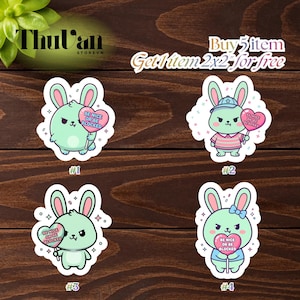 May include: Four stickers featuring cartoon bunnies in various outfits, each holding a heart-shaped sign that reads "BE NICE OR BE BLOCKED." The bunnies are in shades of green and pink, with different accessories. The stickers are on a wooden background.