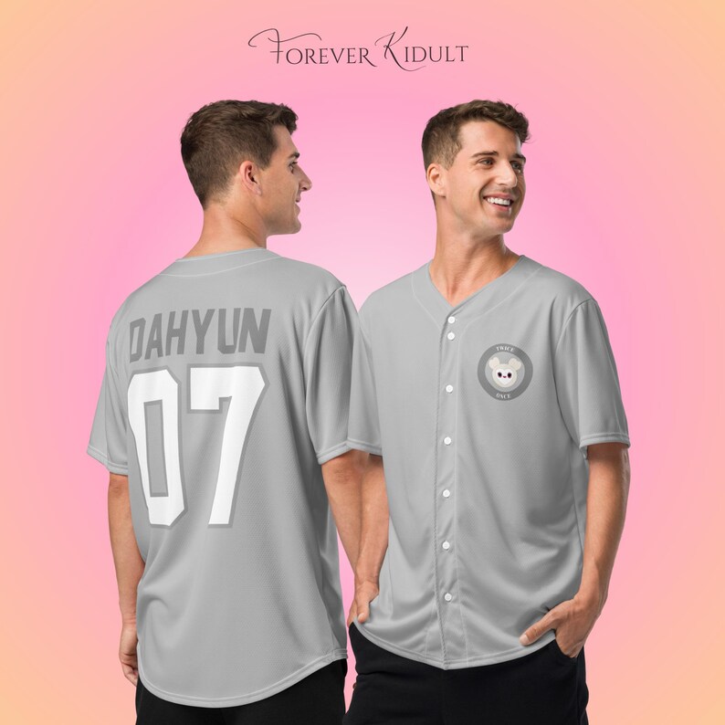 May include: Two gray baseball jerseys. One jersey has the name "DAHYUN" and the number "07" on the back. The other jersey has a circular patch with a bear illustration. The text "FOREVER KIDULT" is at the top.