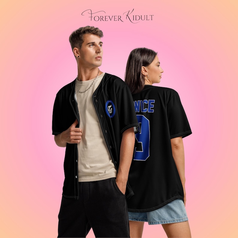 May include: Two people wearing black baseball jerseys with white stitching. The jersey on the left has a blue circular patch. The jersey on the right has the word "TWICE" and the number "9" in blue. The text "FOREVER Kidult" is at the top.