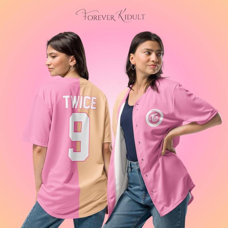 May include: Pink and tan baseball jersey with the word "TWICE" and the number "9" on the back. The front of the jersey has a white logo on the chest. The text "Forever Kidult" is written in cursive at the top.