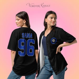 May include: Black baseball jersey with blue detailing. The back of the jersey displays the name "SANA" and the number "96". The front features a blue circular logo with the text "TWICE" and a logo. The text "Forever Kidult" is at the top.