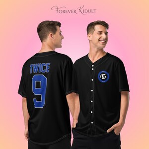 May include: Black baseball jersey with a button-up front and short sleeves. The jersey has the word "TWICE" and the number "9" in blue on the back. A blue and white logo is on the front. The brand name "Forever Kidult" is written in cursive at the top.
