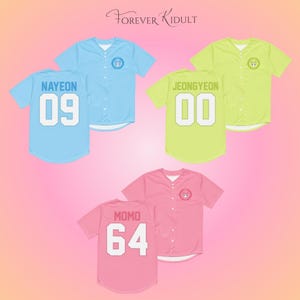 May include: Baseball jerseys in light blue, yellow-green, and pink. Each jersey has a name and number on the back. The light blue jersey has "NAYEON" and "09". The yellow-green jersey has "JEONGYEON" and "00". The pink jersey has "MOMO" and "64".
