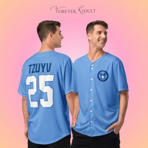 May include: Light blue baseball jersey with the name "TZUYU" and the number "25" in white on the back. The front features a small circular emblem with a cartoon bear. The text "FOREVER KIDULT" is at the top.