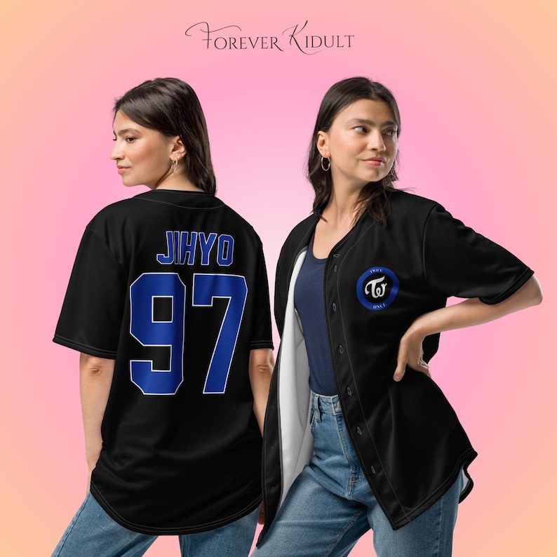 May include: Black baseball jersey with blue lettering displaying "JIHYO" and the number "97" on the back. The front has a circular emblem with "TWICE" and a logo. The jersey is worn over a navy blue top.