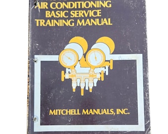 May include: A vintage manual for automotive air conditioning basic service training. The cover is dark blue with yellow and white text and graphics. The manual is titled "AUTOMOTIVE AIR CONDITIONING BASIC SERVICE TRAINING MANUAL" and is published by Mitchell Manuals, Inc.