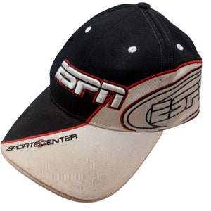 May include: Black and white baseball cap with the ESPN logo embroidered in white and red. The brim is off-white with the text "SPORTSCENTER" in red. The cap has a curved bill and a structured crown.