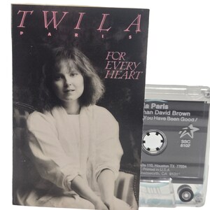 May include: A cassette tape with a clear plastic case and a black label. The label has the text "Twila Paris" and "You Have Been Good/" in white. The cassette tape is for the album "For Every Heart".