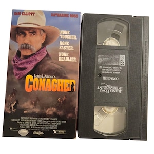 May include: A VHS tape and its case for the movie "Conagher" starring Sam Elliott and Katharine Ross. The case features a cowboy with a mustache and the text "None Tougher. None Faster. None Deadlier."