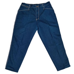 May include: A pair of dark blue denim jeans with a straight leg fit. The jeans have a button fly and belt loops.