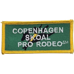 May include: A rectangular embroidered patch with a green background and a yellow border. The patch features a black silhouette of a bucking horse and rider, with the white text COPENHAGEN SKOAL PRO RODEO SM embroidered across the center.
