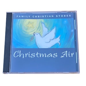 May include: A CD case with the title "Christmas Air" in white script. The cover art features a white dove carrying a sprig, set against a blue background with a star and the text "Family Christian Stores".