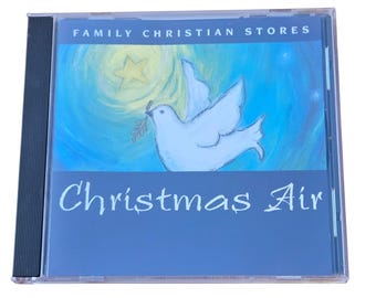 May include: A CD case with the title "Christmas Air" in white script. The cover art features a white dove carrying a sprig, set against a blue background with a star and the text "Family Christian Stores".
