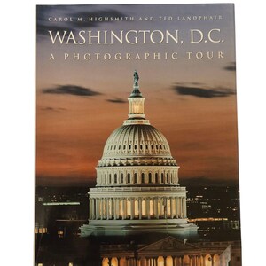 May include: A book titled "Washington, D.C. A Photographic Tour" by Carol M. Highsmith and Ted Landphair. The cover features a nighttime photo of the US Capitol building.