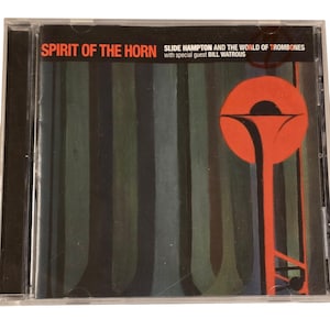 May include: CD case with the text "SPIRIT OF THE HORN" and "SLIDE HAMPTON AND THE WORLD OF TROMBONES". The cover features a red trombone graphic on a striped background of green, gray, and black.