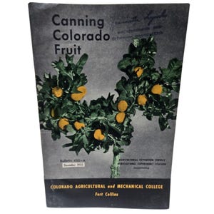 May include: Vintage book cover titled "Canning Colorado Fruit" with a black and white image of a fruit-bearing tree. The cover includes text such as "Bulletin 435-A December 1955" and the name of the college in Fort Collins.