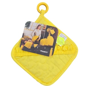 May include: A bright yellow quilted pot holder with a matching hanging loop. A product tag features a woman in a kitchen with yellow kitchen accessories. The tag reads "FRANCO".