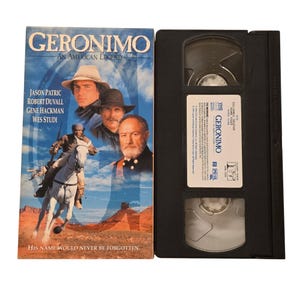 May include: A VHS video cassette and its cover for the film "Geronimo: An American Legend." The cover shows Jason Patric, Robert Duvall, Gene Hackman, and Wes Studi. The text "His name would never be forgotten" is at the bottom.